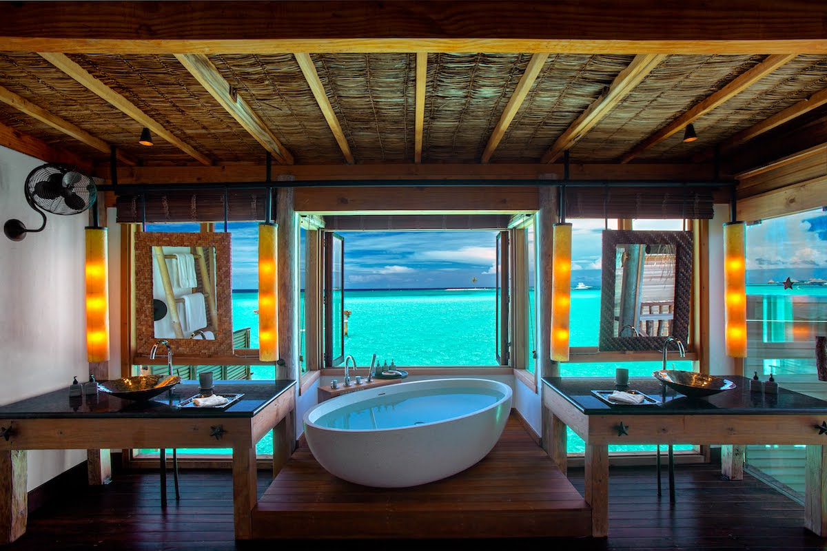 A bathroom in the Maldives, overlooking the Indean Ocean with freestanding bath and twin vanity sinks.jpg