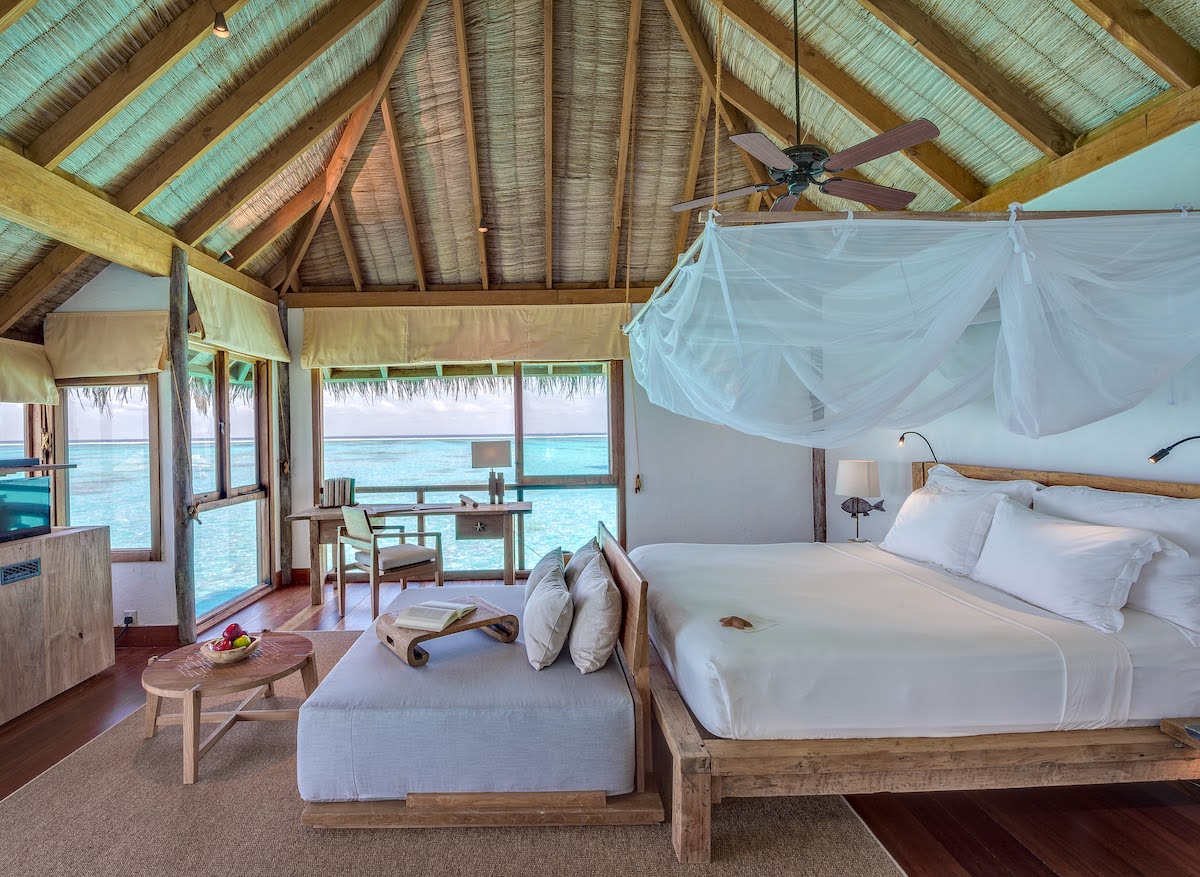 A bedroom in a villa at Gili Lankanfushi, overlooking the water in the Maldives