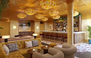bar area with statement lighting and rounded comfortable seating in Locke Paris by edyn