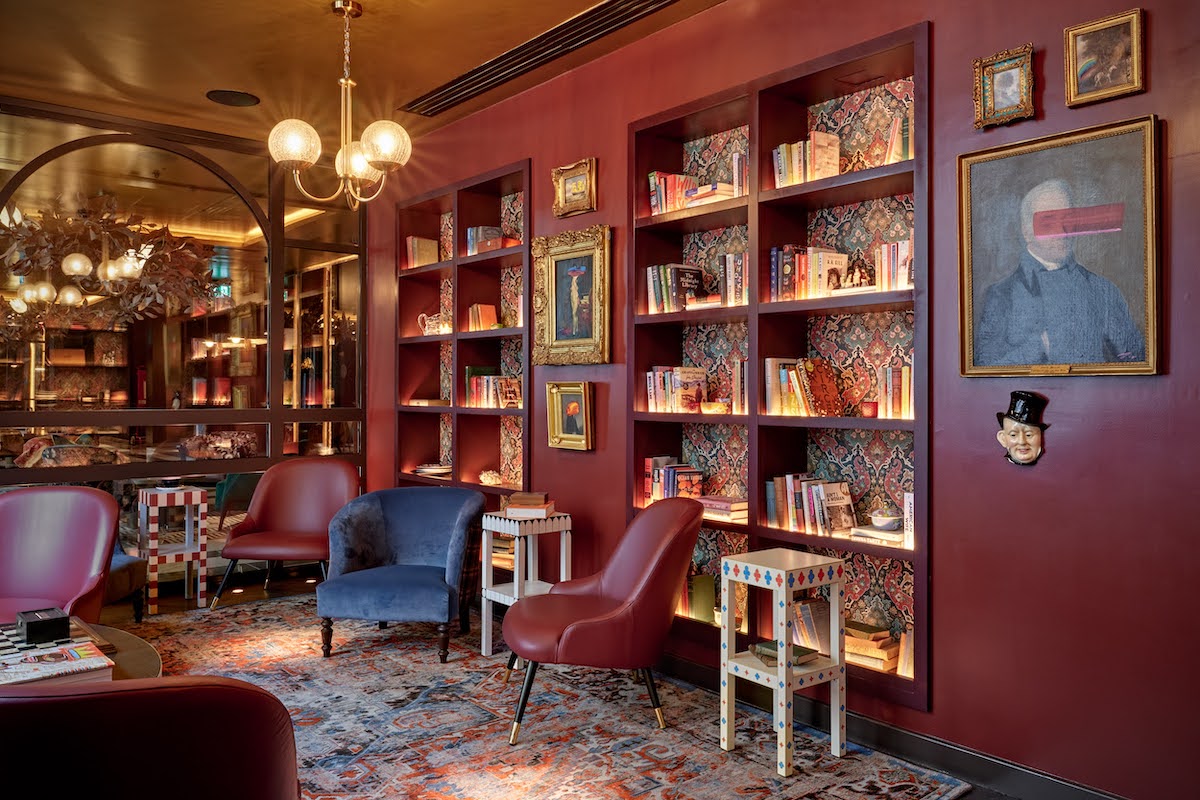 The Library inside The Other House South Kensington with red interior design scheme