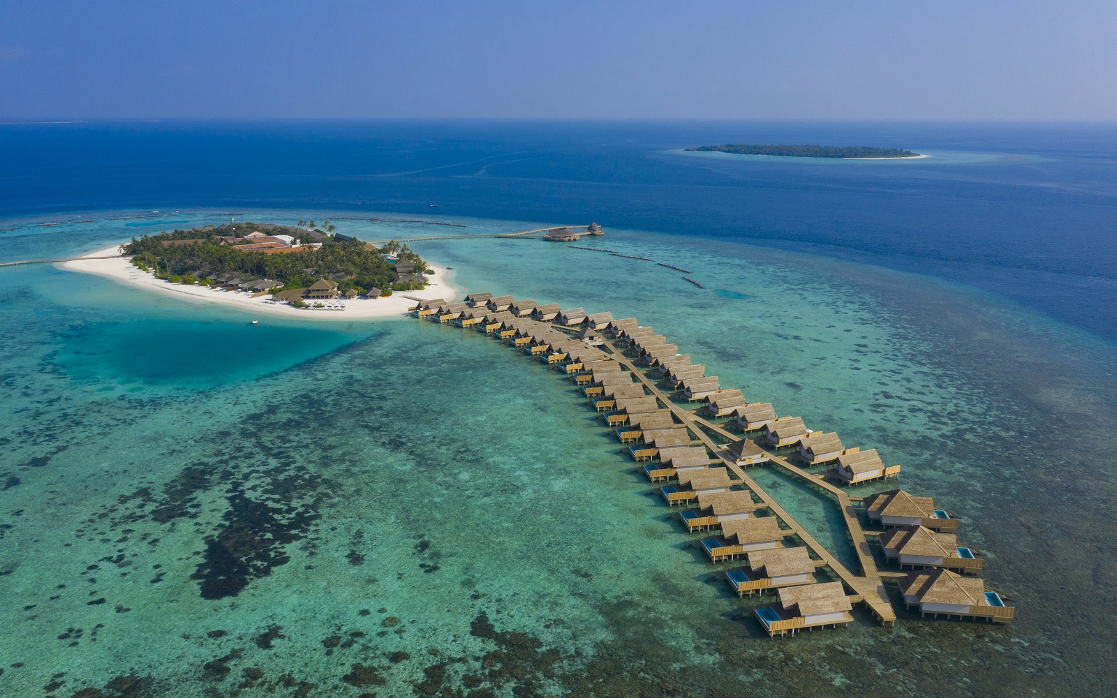 aerial view of island and guestrooms over lagoon at Emerald Collection Faarufushi