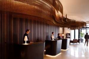 Bronze Kaynemaile mesh used as a feature behind reception in Crowne Plaza hotel