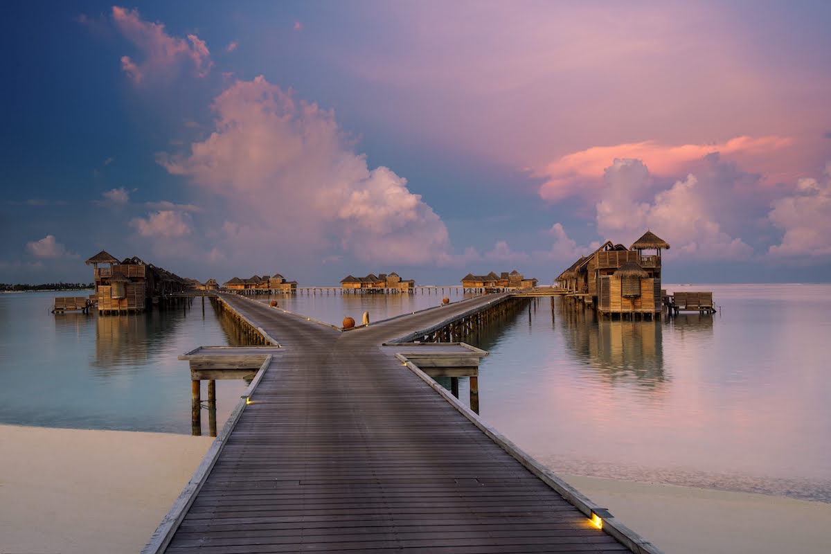 Jetty at sunset towards villas in the Maldives