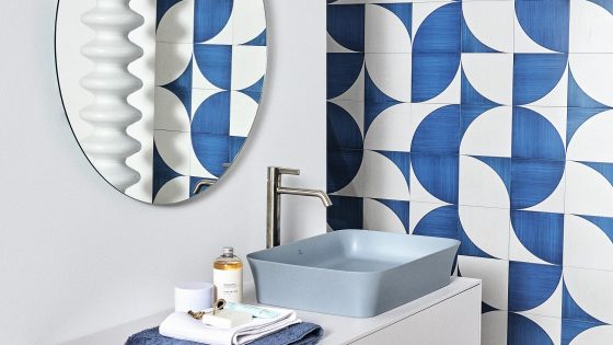 blue and white hotel bathroom design with blue basin by Ideal Standard