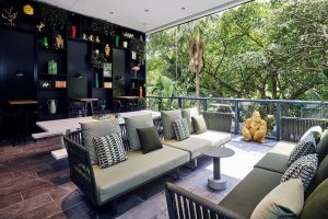 public seating space in Miami Brickell citizenM with windows overlooking the garden and feature black wall
