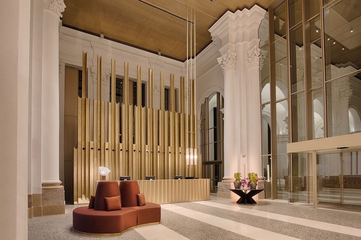 the lobby in the NH Collection Milano with design elements from the church including reference to church organ