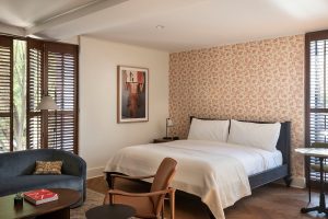 wallpaper, art and vintage furniture in guestroom at The Quoin
