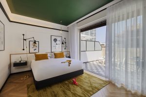 terraced guestroom at Theodor Brown Hotel with green ceiling and graphic art deco details