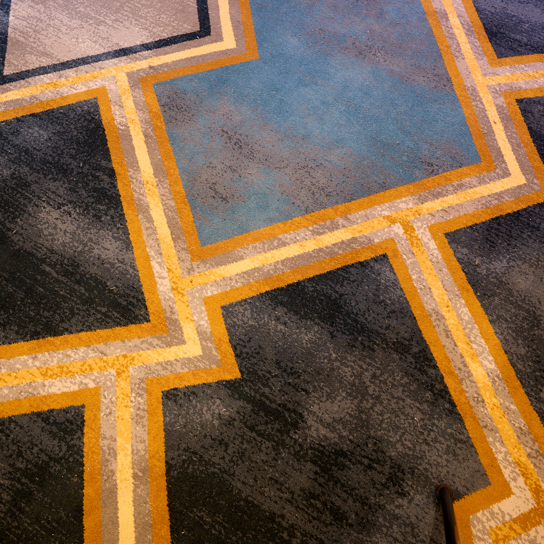 close up carpet detail of geometric blue and gold pattern by Modieus for Petersham RSL Club