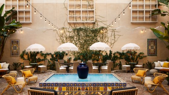Pasadena Hotel & Pool courtyard with outdoor furniture and yellow pops of colour