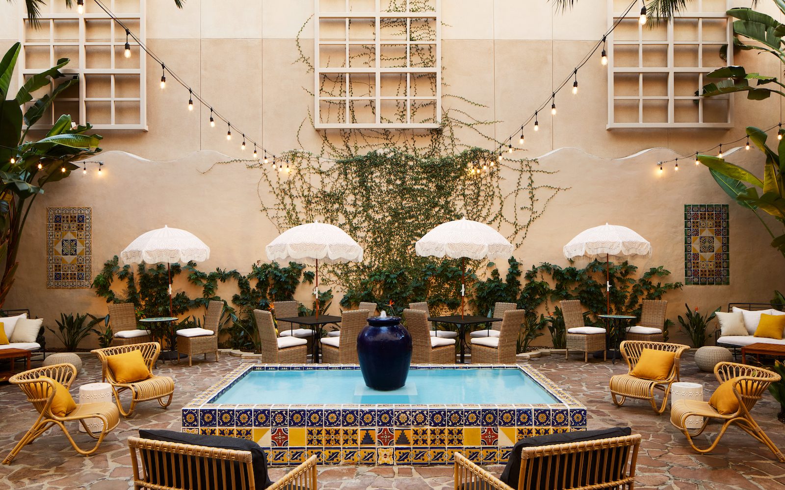 Pasadena Hotel & Pool courtyard with outdoor furniture and yellow pops of colour
