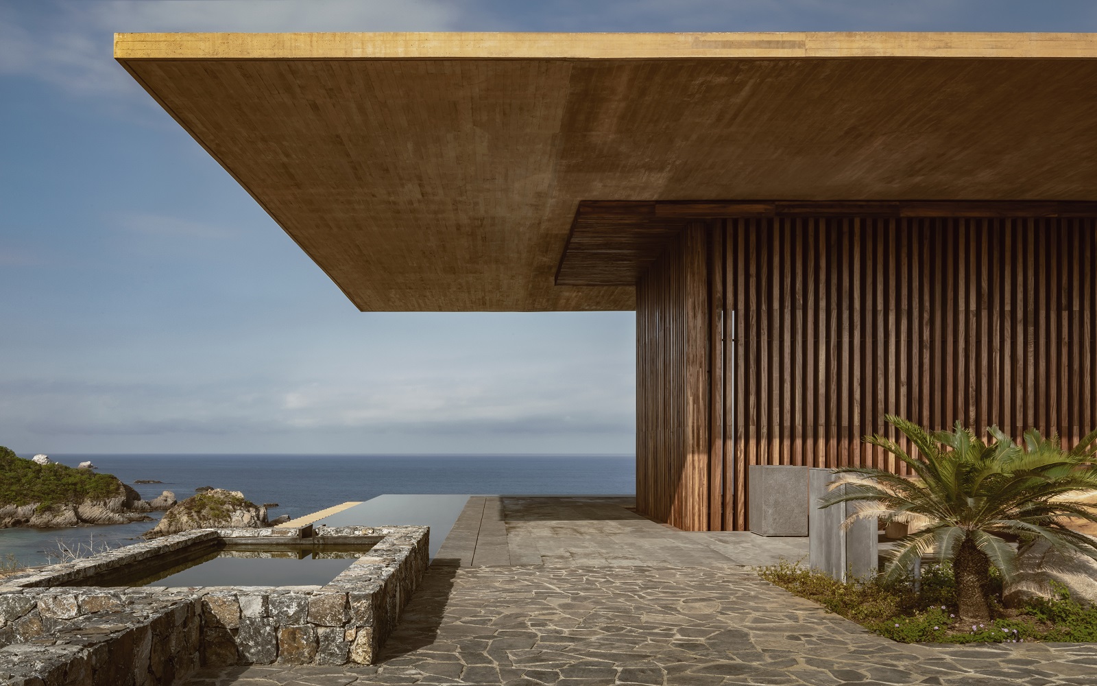 concrete and wood facade at Four Seasons Tamarindo with views over the pacific ocean