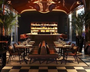 cocktail bar with curved ceiling and dramatic lighting at hotel Les Bains Paris