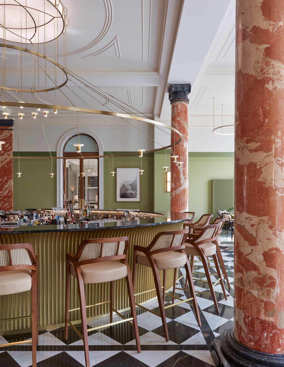circular bar at Mandarin Oriental Palace Luzern in sage green with terracotta pillars