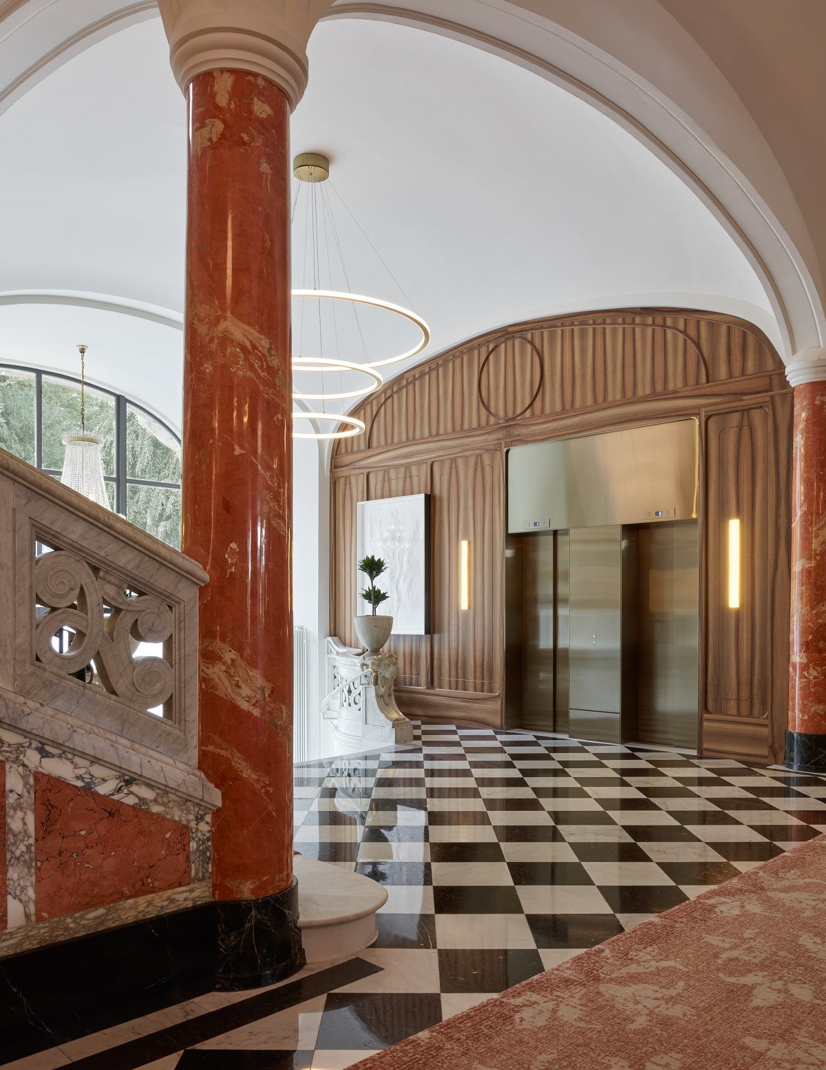 entrance and lobby at mandarin oriental Palace luzern with design by Jestico + Whiles incorporating black and white marble floor and restored terracotta marble pillars