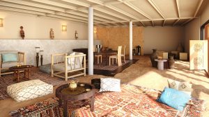 Caravan by Habitas Dakhla reception area with traditional moroccan carpets and floor cushions
