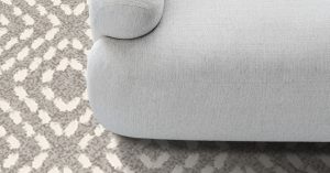 detail of edge of couch with modieus carpet inspired by natural colours