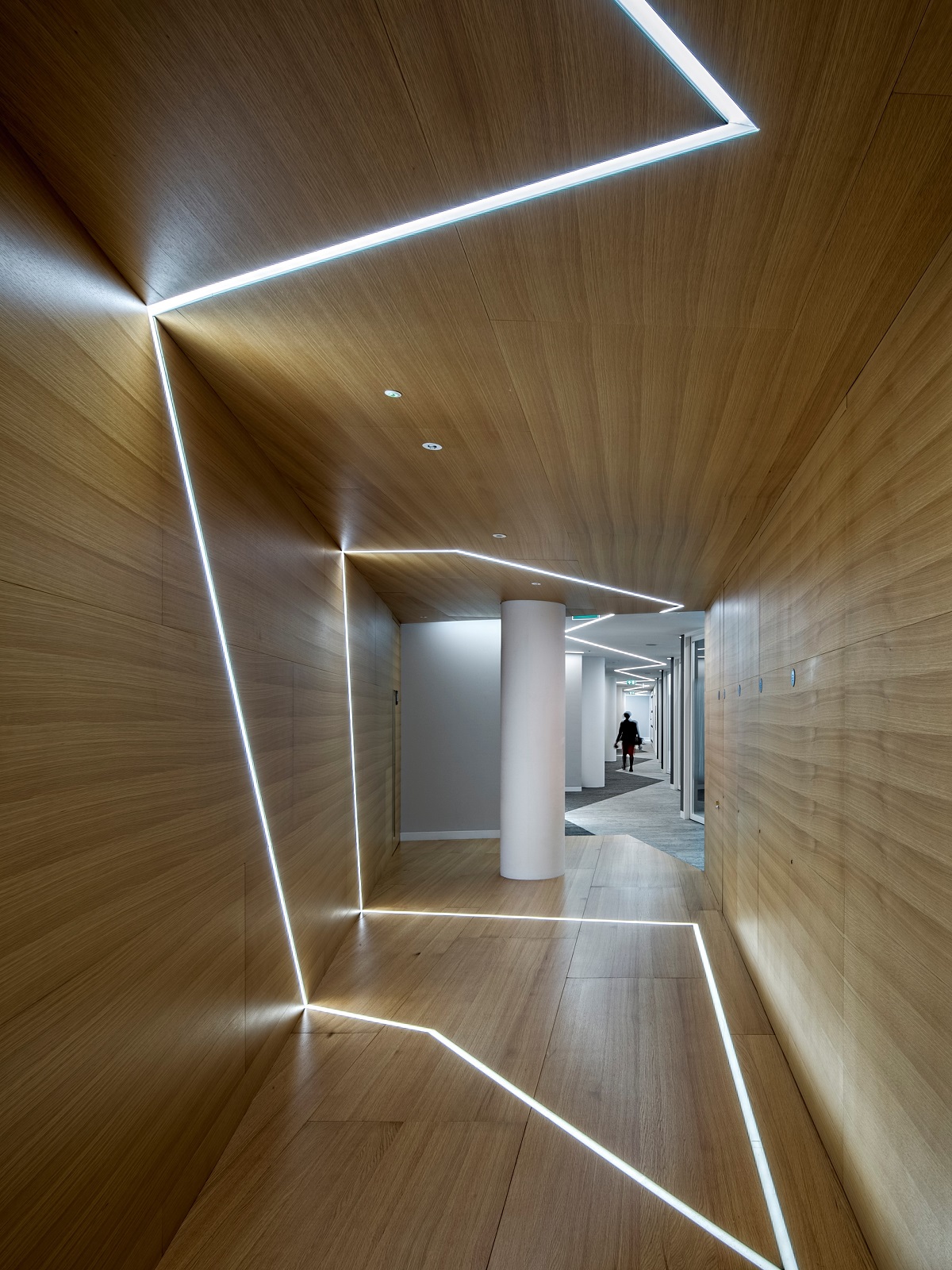directive and graphic lighting in a passage by elektra lighting design