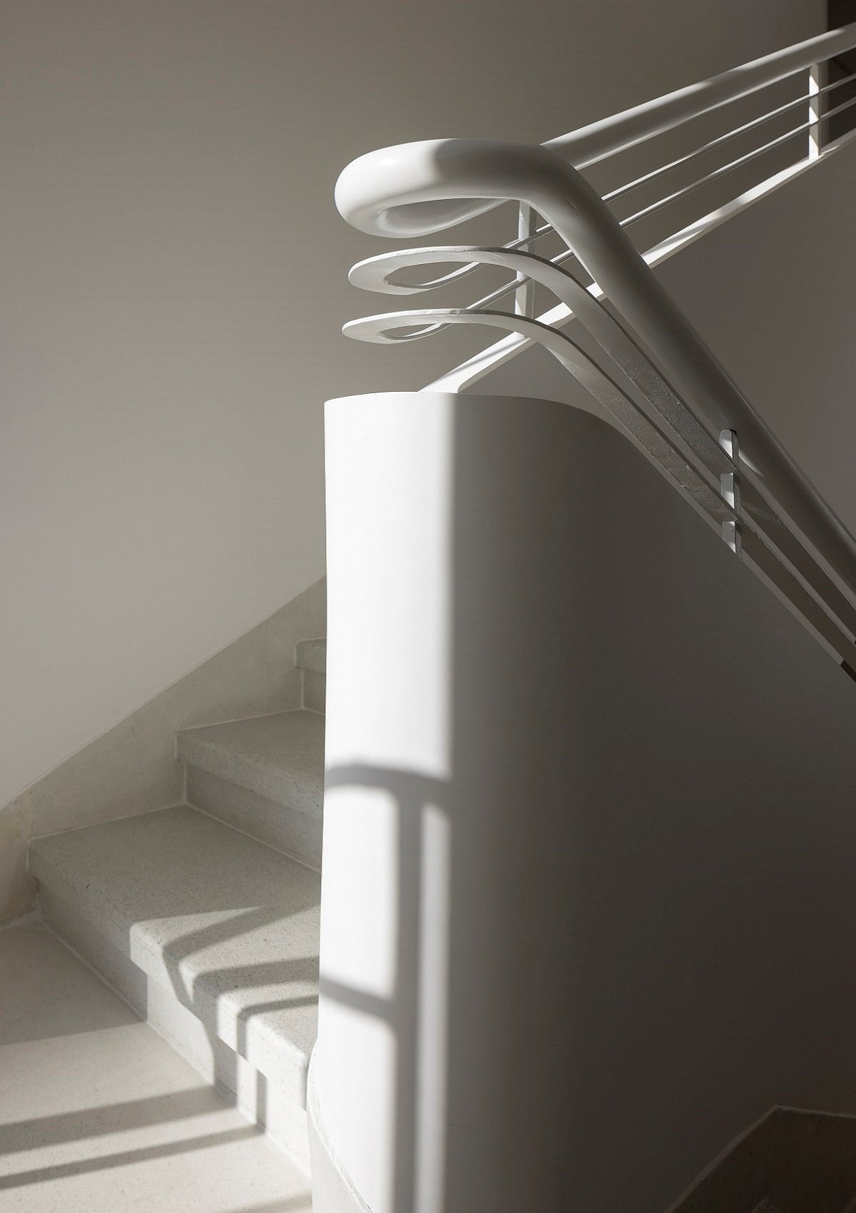 white curved detail of staircase in R48 Hotel and Garden