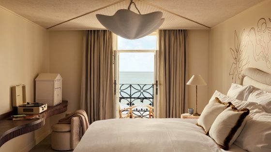 guestroom in No.42 by GuestHouse decorated in warm neutrals with balcony and seaview
