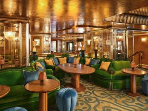 gold surfaces, ceilings and walls with plush velvet seating in The Vesper Bar at The Dorchester