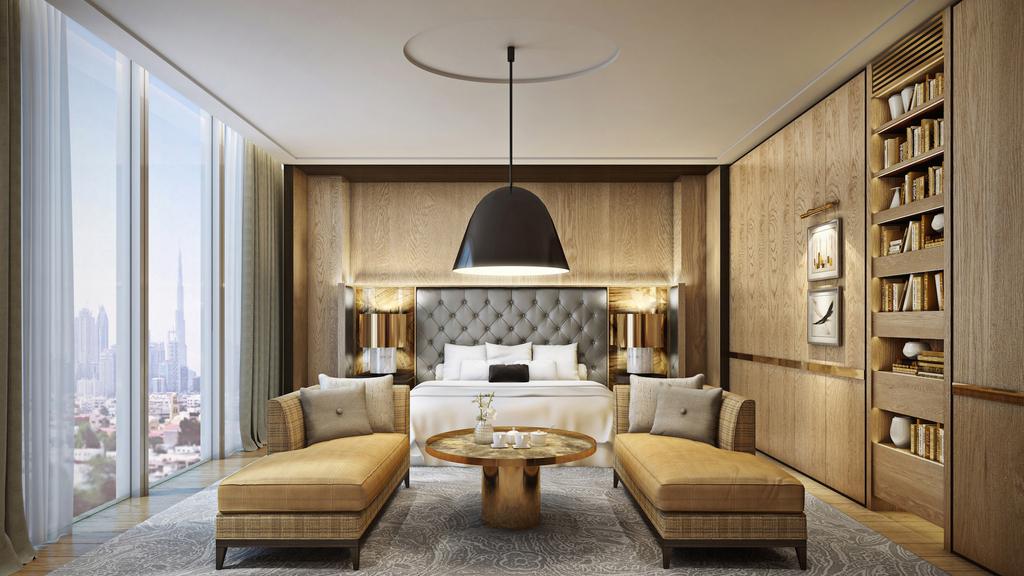 Luxury bedroom inside hotel with large lamp over bed