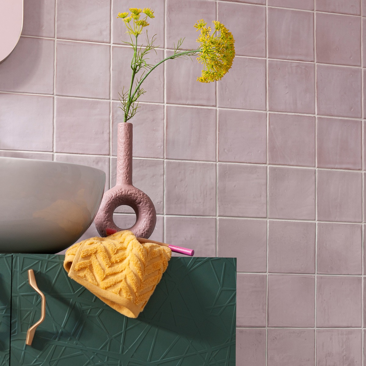 handbasin and vase with yellow flowers and Nador pink gloss tiles from CTD Tiles