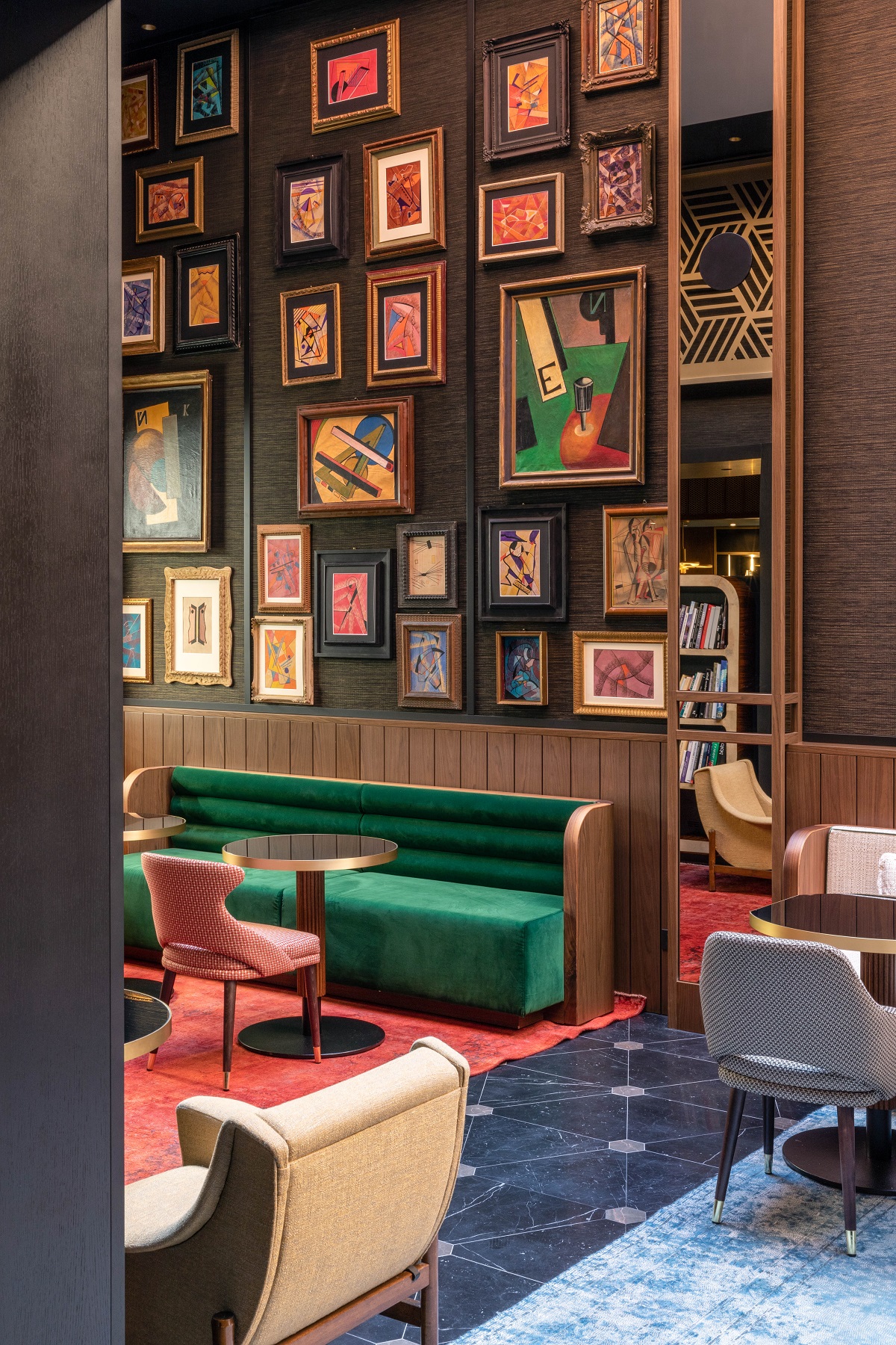 public seating in hotel lobby with green couch and colourful prints