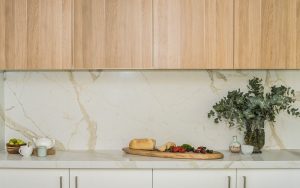 Calacatta backsplash in a kitchen with wooden cupboards made from Trascenda by TREND Group