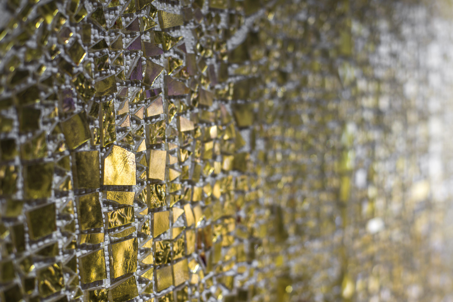 detail of textured gold mosaic tiles from TREND Group