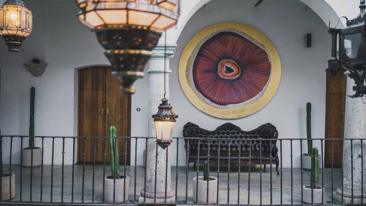 lanterns and architectural arches frame contemporary art at Hotel Sin Nombre