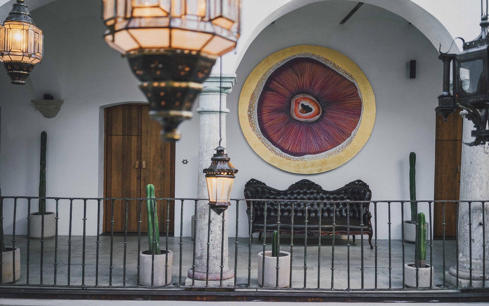 lanterns and architectural arches frame contemporary art at Hotel Sin Nombre