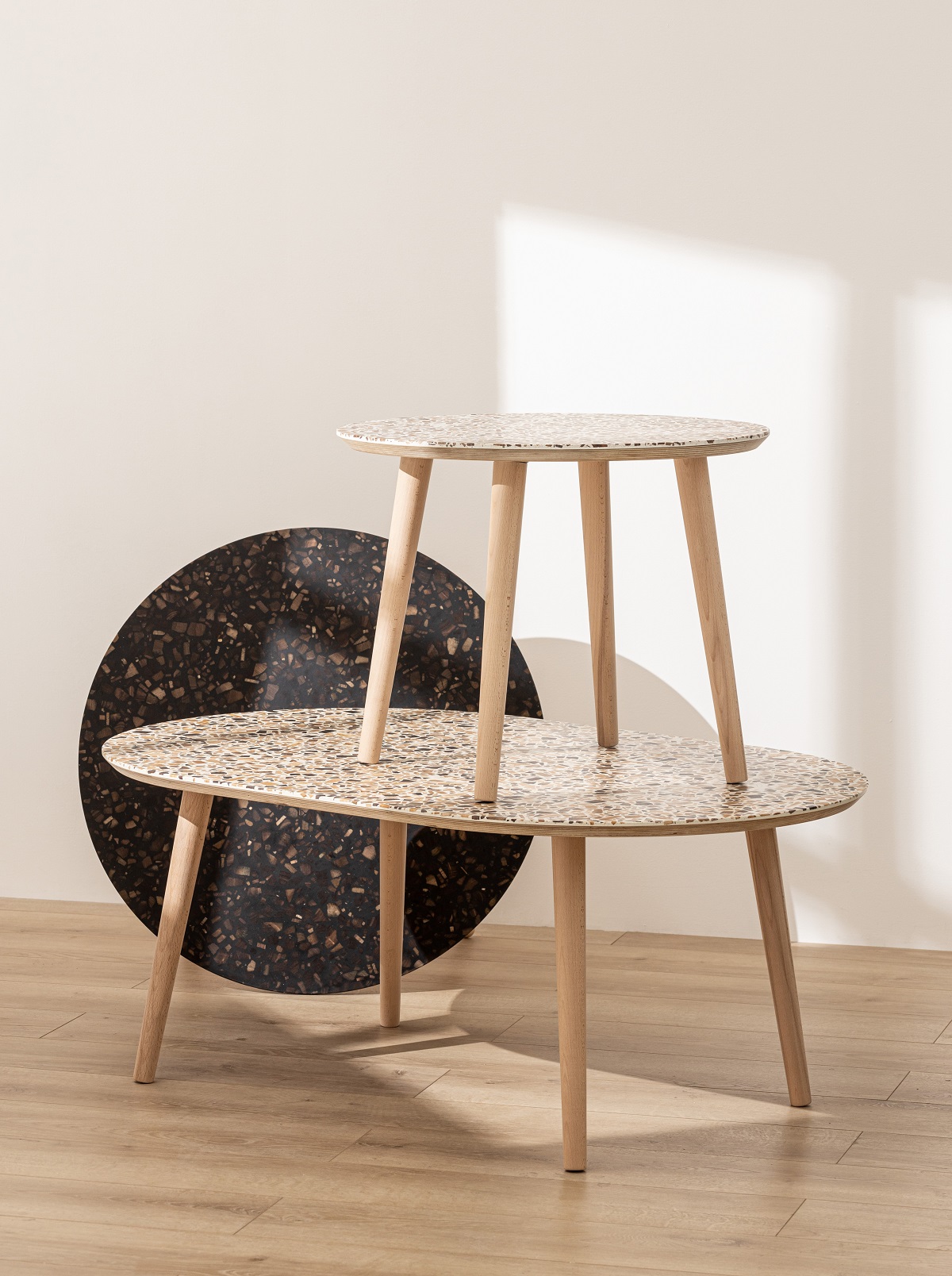 a collection of three tables with Foresso wood terrazzo surface design detail