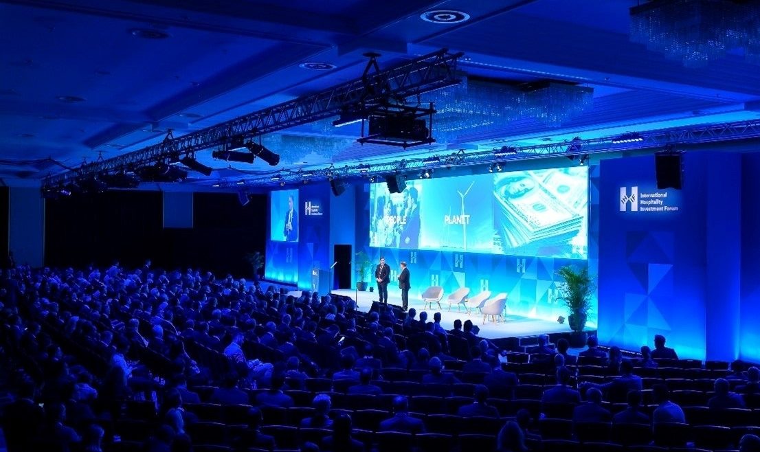 blue lighting on stage at the International Hospitality Investment Forum