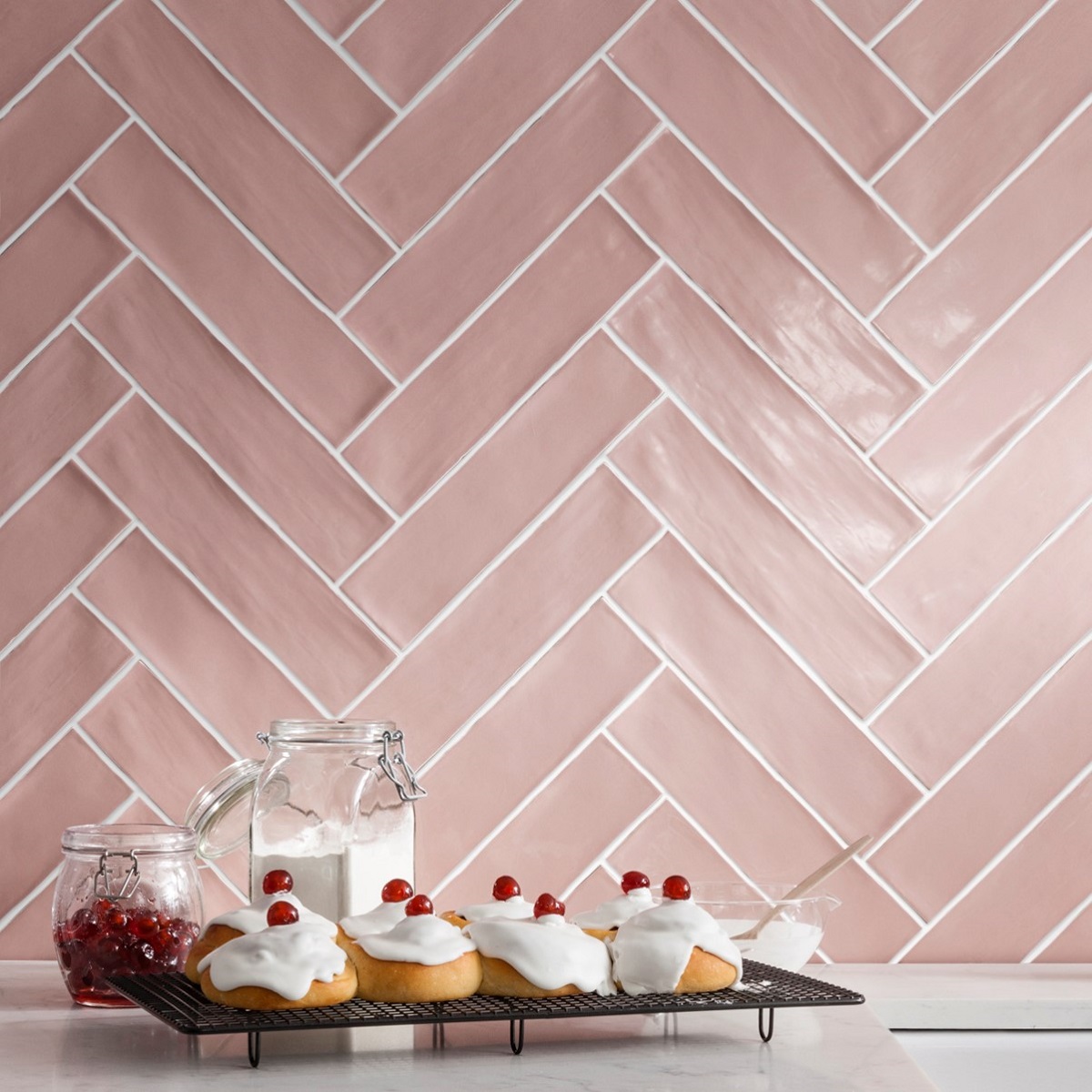 pink Poitiers tiles with contrasting white grout on the wall in herringbone pattern from CTD tiles