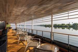 wooden terrace with river view at the Radisson Blu Mosi-oa-Tunya, Livingstone Resort - River Cruiser Restaurant