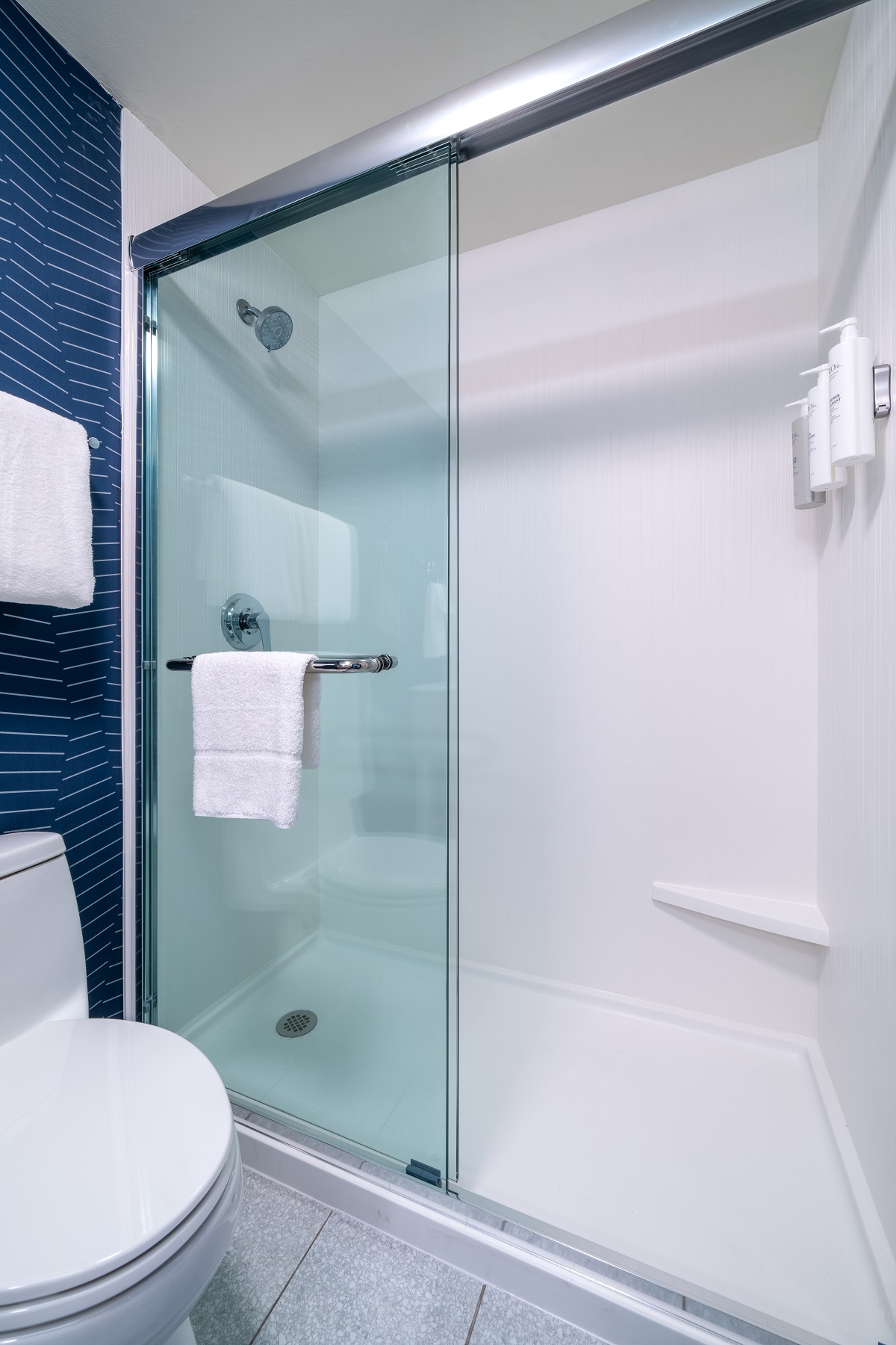 blue walls, glass shower screen in bathroom by Spark by Hilton