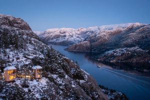 aerial view of The Bolder cabins perched over the snowy fjords of Norway