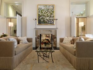 couches and fireplace in coworth park lounge with lighting on tables by Dernier & Hamlyn