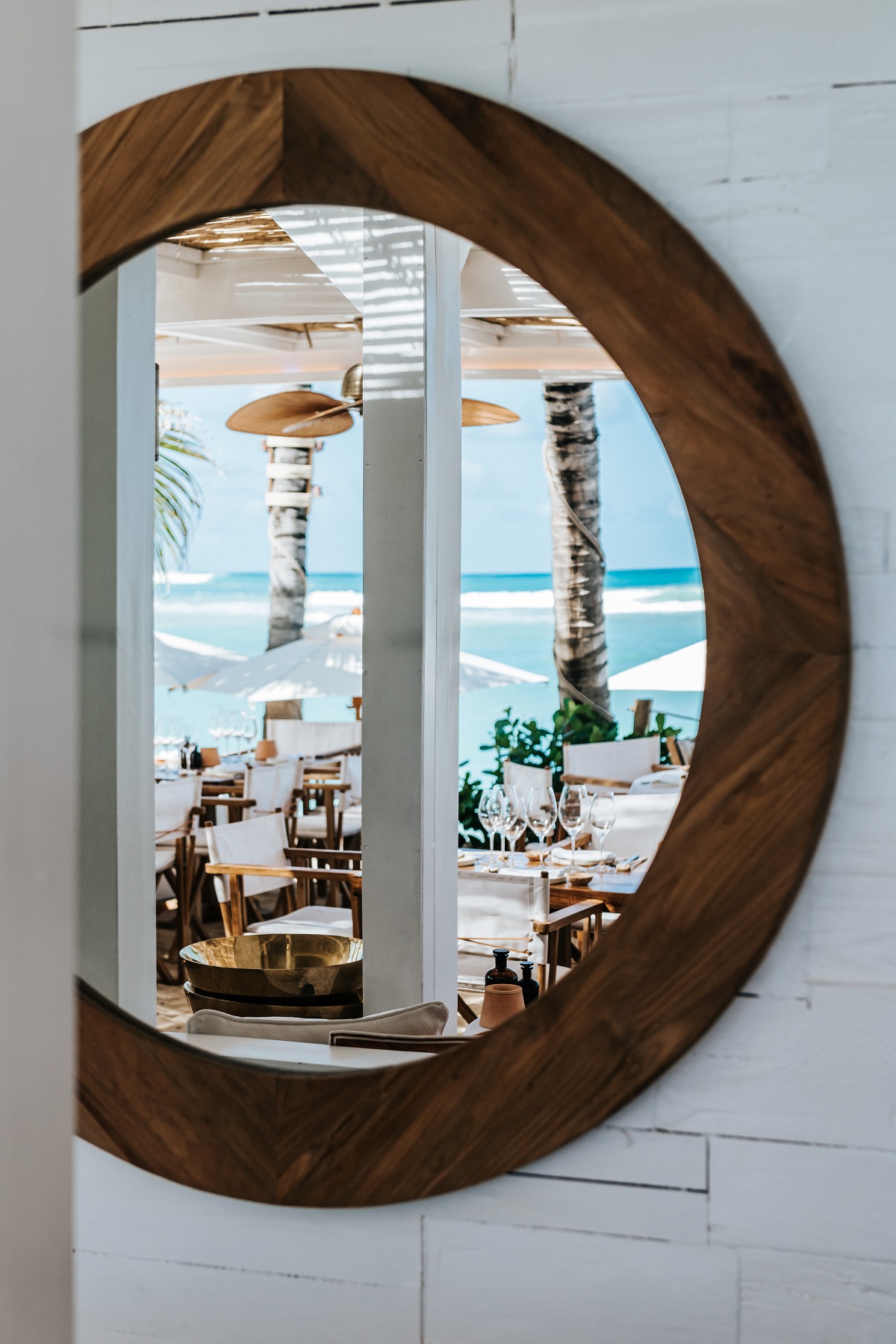 a porthole mirror at Nao Beach reflecting the design and location