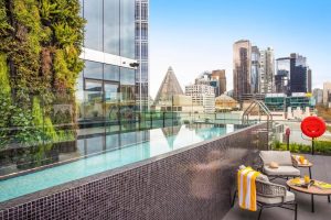 pool and terrace with seating at voco Melbourne