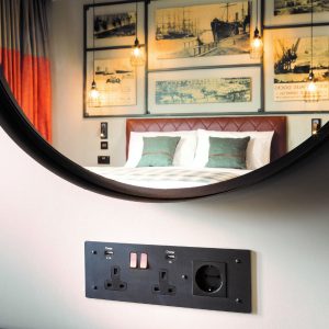 plug socket design and detail below mirror at Hotel Indigo in Cardiff