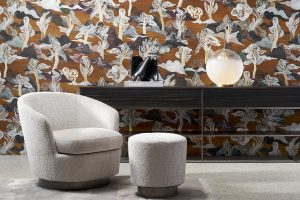 curved cream chair in front of Saranda wallcovering by Arte