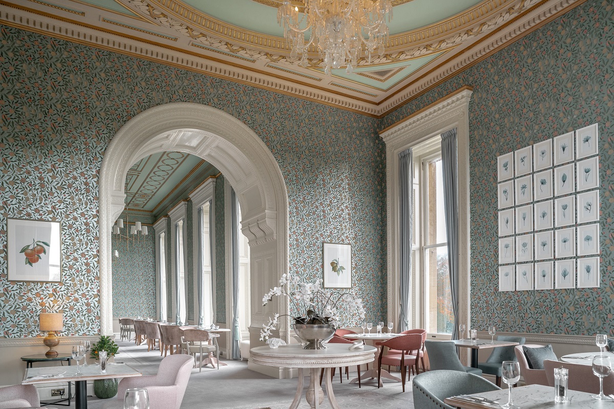 the Brasserie at Heythrop PArk with patterend blue wallpaper and painted ceilings with ornate mouldings