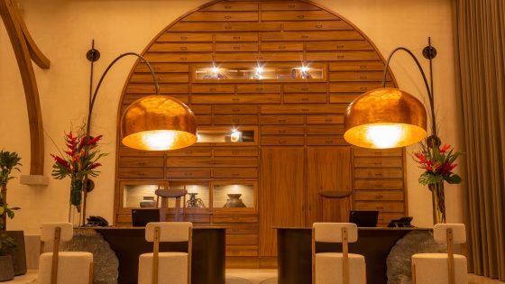 Front desk at NUMU with wood panelling and statement bell lighting Hyatt Unbound Collection