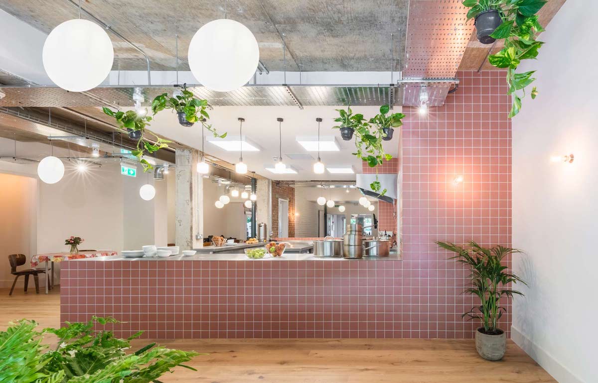 Pink-tiled, softly designed canteen area in homeless shelter