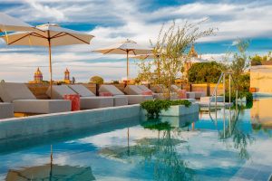 umbrellas and sunloungers around the rooftop pool of NUMU Boutique Hotel