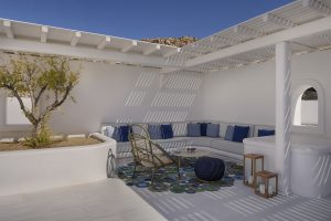 white walls and blue cushions on built in seating in the central courtyard at Mykonos Grand Villa