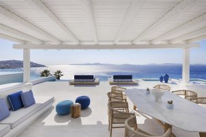 white architecture and blue accessories look out over the sea at Mykonos Grand villa 