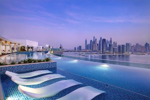 view across the pool to the Dubai skyline at NH Collection Dubai The Palm